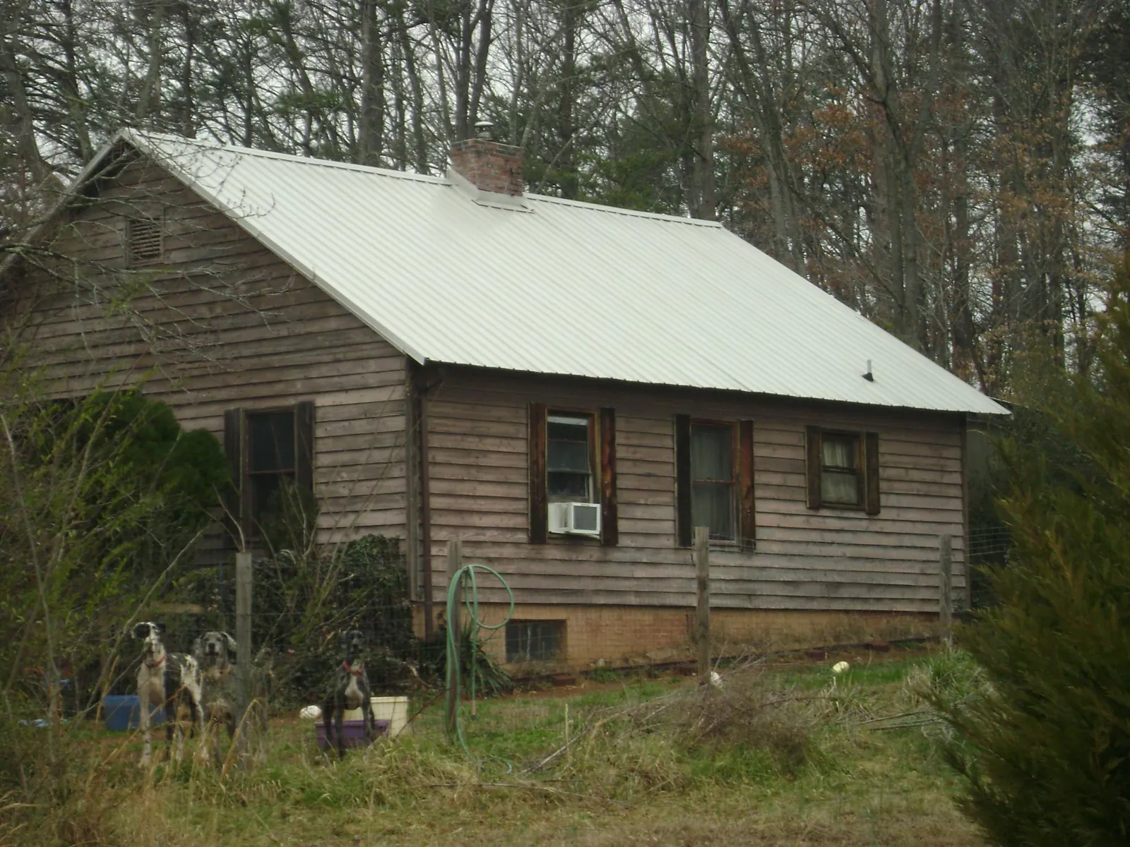 White metal roof on an old wood sided farmhouse, from a Asphalt Shingle Roof Repair job in Eatonton